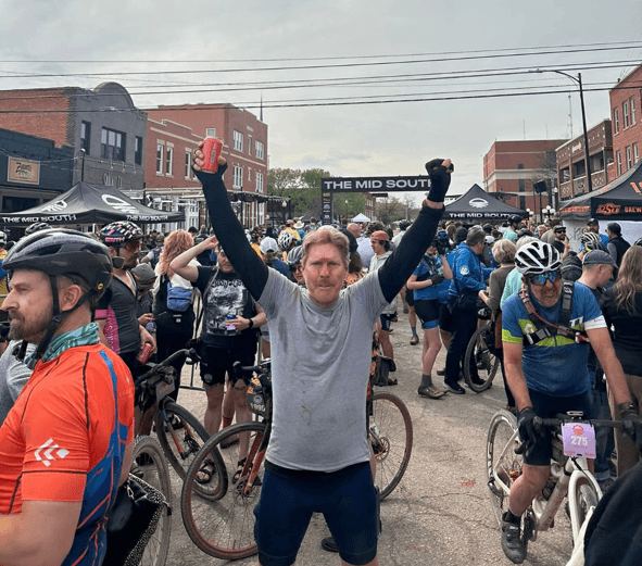 Michael cheering at a cycling event in downtown Stillwater